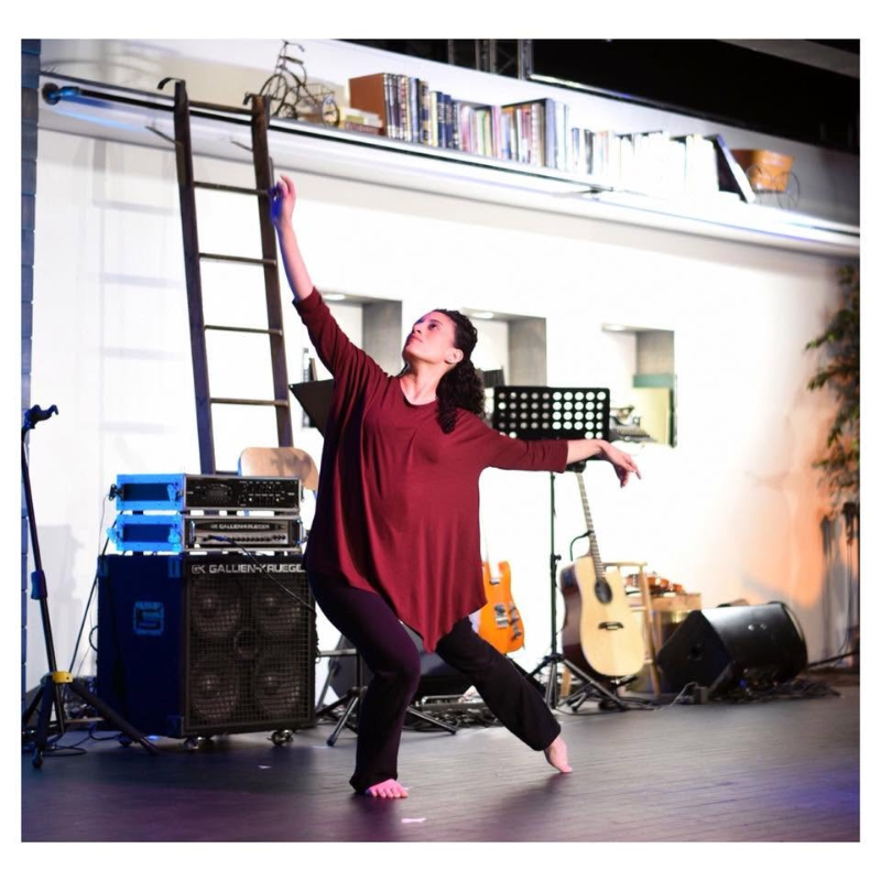 An instructor of DG School of the Arts in a moment of fluid, graceful movement, illustrating the intersection of technique and spirit.