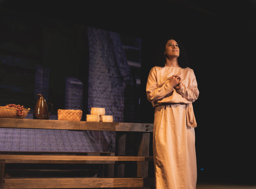 Expressing a moment of deep, prayerful reflection during a stage production